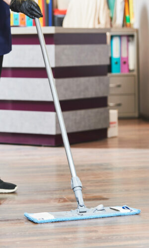 cleaning service. washing office floor surface with mop